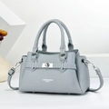 Close-up of light blue lychee pattern leather handbag with silver hardware and twist lock - Blue