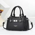 Detail of black litchi grain leather tote with silver lock and adjustable shoulder strap - Black