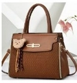 Brown faux leather handbag with textured base and yellow bear charm attachment - Earthy Yellow