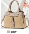 Detail of khaki corduroy handbag featuring grey-pink handles and metallic logo charm - Khaki