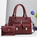 Macro shot of dark red lychee leather handbag set with silver hardware and tulip decor - Burgundy