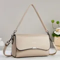 Detail of beige pebble leather flap bag with dark metallic hardware and dual straps - Khaki