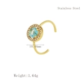 Detail of gold stainless steel ring with light blue center stone and zircon halo - Blue