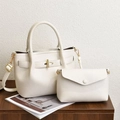 Chic beige lychee textured handbag set with gold hardware on a wooden table - Off White