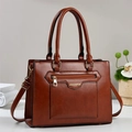 Detail of dark brown tote bag showing croc texture leather and golden zipper hardware - Earthy Yellow
