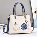 Beige and blue embroidered handbag with floral butterfly patterns and crossbody strap - Blue