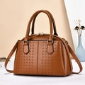 Brown woven tote bag with adjustable strap and golden zipper on white surface - Earthy Yellow