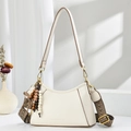 Detail of cream shoulder bag with lychee texture, brown trim, and woven strap accent - Off White