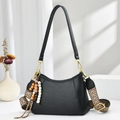 Black pebbled leather half-moon shoulder bag with colorful woven strap and beaded tassel - Black