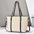Detail of minimalist tote bag with woven texture, leather trim and detachable shoulder strap - Gray