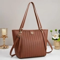 Close-up of vertical embossed texture and golden logo on brown vintage tote bag - Earthy Yellow