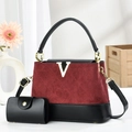 Detail of red and black quilted handbag with golden V logo and matching small pouch - Wine Red