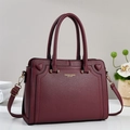 Deep red lychee textured leather handbag with gold hardware and heart embossed details - Burgundy