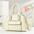 Close-up of litchi texture on beige handbag with gold studs and smooth edge painting - Off White