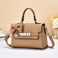 Brown lychee leather handbag with bow and pearl detail on a stylish lifestyle background - Khaki