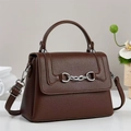 Dark brown pebbled leather satchel with horsebit buckle and top handle shown in 45-degree angle - Coffee