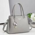 Detail of grey lychee leather handbag with seashell pendant and fashion text engraving - Gray