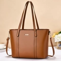 Elegant brown leather tote bag with gold metal hardware and adjustable shoulder strap - Earthy Yellow