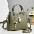 Olive green textured leather handbag with silver twist lock and ocean theme pendant - Green