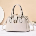 Detailed macro view of cream tote bag featuring lychee texture and gold metal buckle - Off White