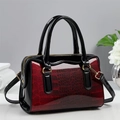 Detail of red and black gradient crocodile pattern Boston bag with gold hardware - Burgundy