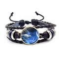 Detail of woven leather bracelet featuring a white wolf running under a starry sky design - White Wolf Running in Starry Sky (JY00329-10)