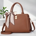 Brown lychee leather tote bag with silk scarf and adjustable strap on a clean background - Earthy Yellow