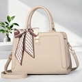 Detail of apricot tote bag with lychee texture, silk scarf handle and gold metal lock - Off White