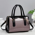 Close-up of pink glitter texture with black patent leather trim and gold metal hardware - Pink