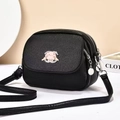 Detail of black lychee grain crossbody bag with cartoon pig logo and double zipper - Cartoon Pig Metal Logo Style (6022)