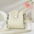 Close-up of creamy white bucket bag featuring lychee grain leather and silver hardware - Off White