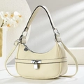 Detail of creamy litchi grain leather underarm bag with silver metallic clasp closure - Off White