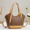 Brown contrast leather handbag with adjustable strap for women in elegant studio setting - Coffee