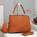 Detail view of brown pebbled leather handbag with gold V-hardware and strap - Earthy Yellow