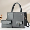 Close-up of grey patchwork tote bag with matching pouch and gold hardware details - Gray