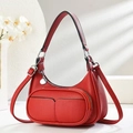 Detail of red litchi leather hobo bag showing front zip pocket and silver hardware - Burgundy