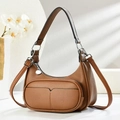 Detailed view of brown litchi leather crescent bag with adjustable strap and silver hardware - Brown