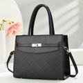 Luxurious black textured leather handbag with gold twist lock and elegant crossbody strap - Black