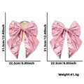 Fiocco di Natale rosa con paillettes e specifiche di dimensioni 31,5 cm su sfondo bianco - Rosa