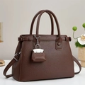 Detail of dark brown lychee grain leather handbag with matching mini pouch and shoulder strap - Coffee