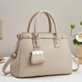 Detail of lychee pattern leather handbag with silver hardware and mini bag charm - Khaki