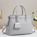 Elegant light gray lychee grain leather tote bag with silver hardware and pendant - Gray