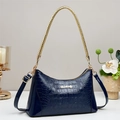 Detail of navy blue crocodile pattern leather bag with golden woven handle and brand logo - Blue