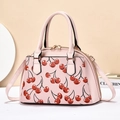 Pink shell handbag with cherry print, featuring dual handles and a crossbody strap - 31x20x14cm / Pink