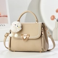 Chic beige lychee leather satchel with gold lock, top handle and plush charm detail - L22xH17xW12 / Khaki