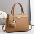 Caramel lychee textured leather handbag with a heart pendant and adjustable shoulder strap - Dark Khaki