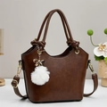 Elegant brown PU leather bucket bag with knotted handles and a white fluffy pompom charm - Coffee