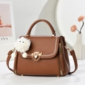 Brown litchi grain crossbody bag with white stitching and plush monster charm - L22xH17xW12 / Earthy Yellow
