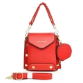 Detailed macro view of red crocodile pattern leather bag with woven handle and gold studs - Red