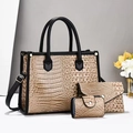 Detailed close-up of beige crocodile pattern handbag set with black trim and gold hardware - Khaki